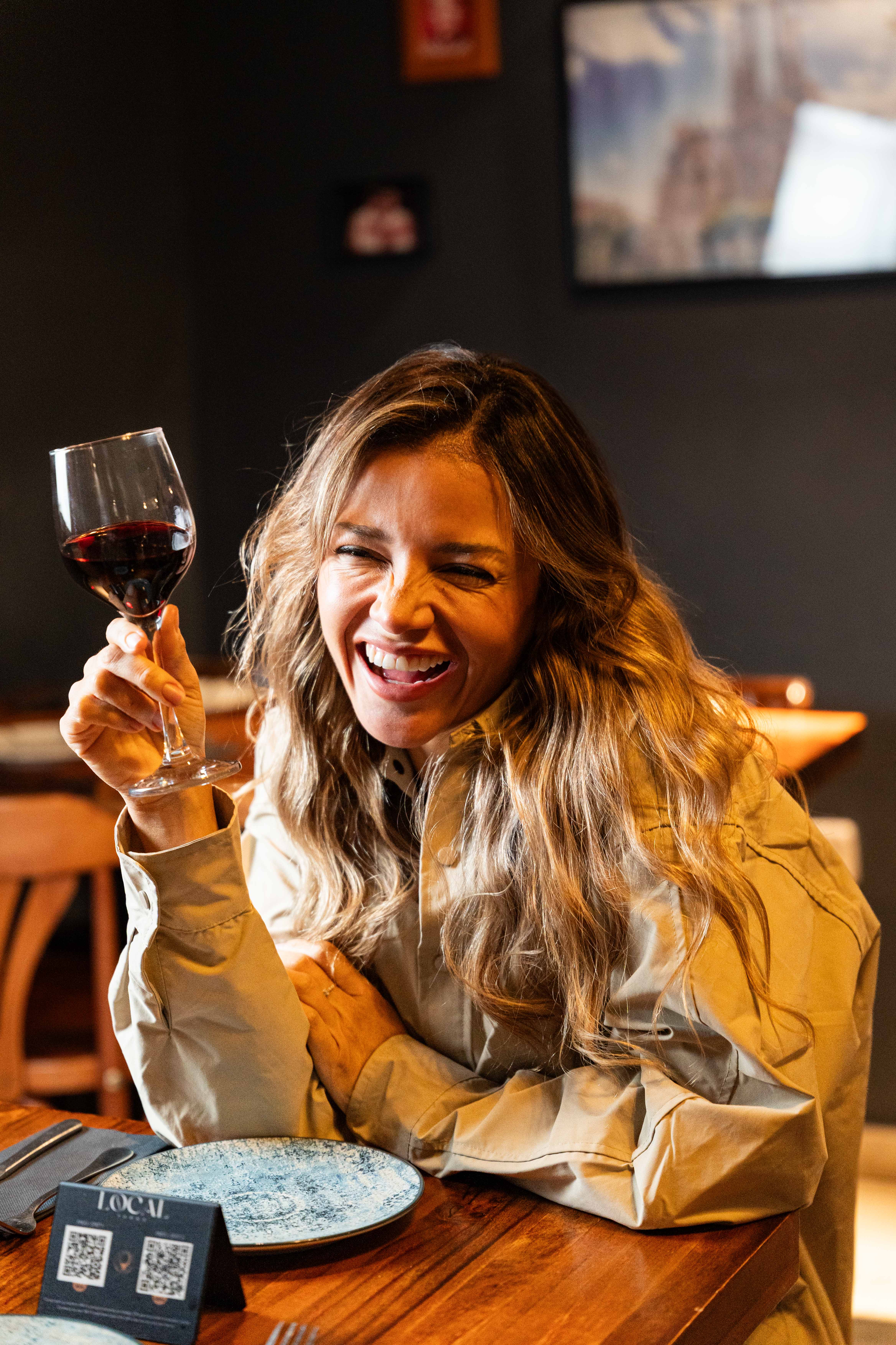 Guest enjoying Spanish wine at Local Tapas